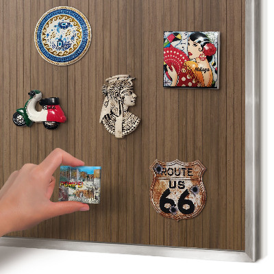 Souvenir magnet display board with a silver frame Wooden background