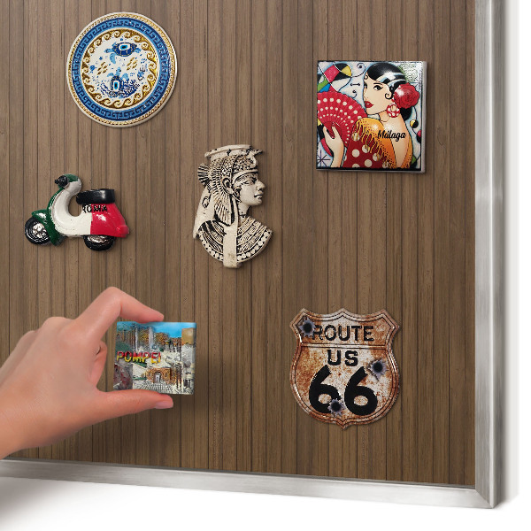 Souvenir magnet display board with a silver frame Wooden background