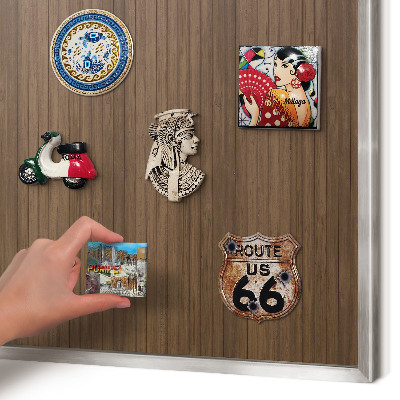 Souvenir magnet display board with a silver frame Wooden background