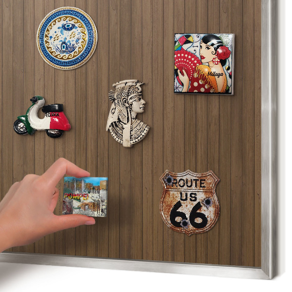 Souvenir magnet display board with a silver frame Wooden background