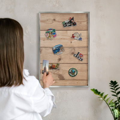 Souvenir magnet display board with a silver frame Wooden texture
