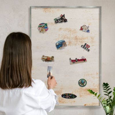 Souvenir magnet display board with a silver frame Rusty texture