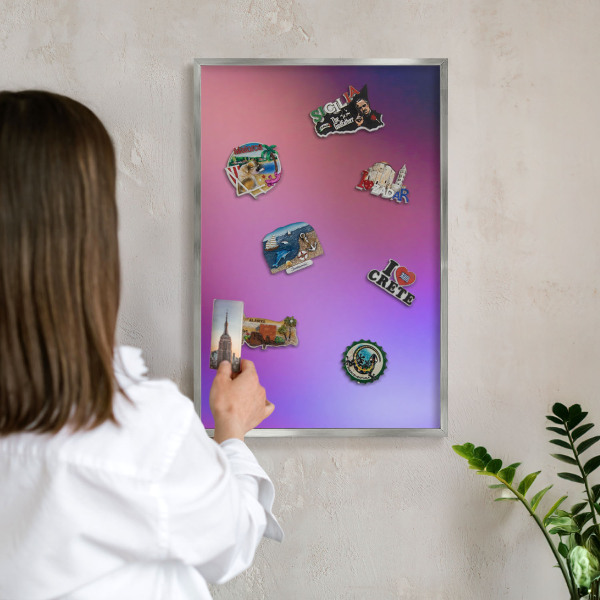 Souvenir magnet display board with a silver frame Colors of harmony