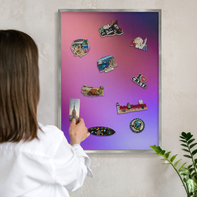 Souvenir magnet display board with a silver frame Colors of harmony