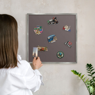 Souvenir magnet display board with a silver frame Faded brown
