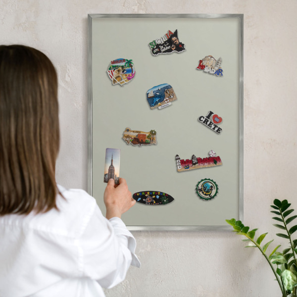 Souvenir magnet display board with a silver frame Warm gray
