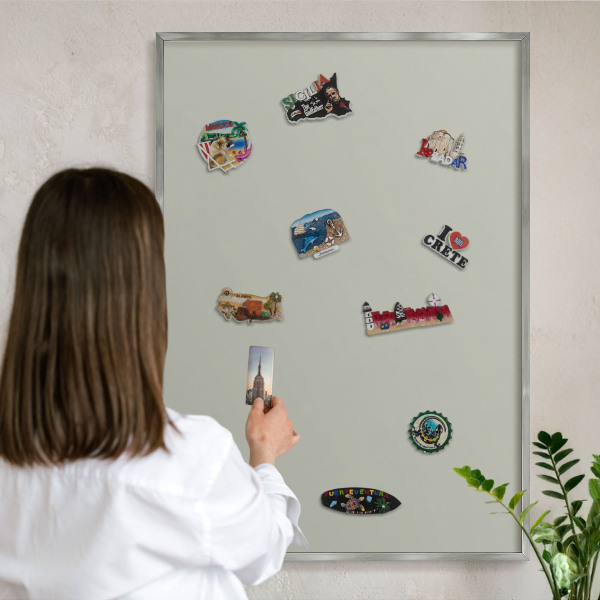 Souvenir magnet display board with a silver frame Warm gray