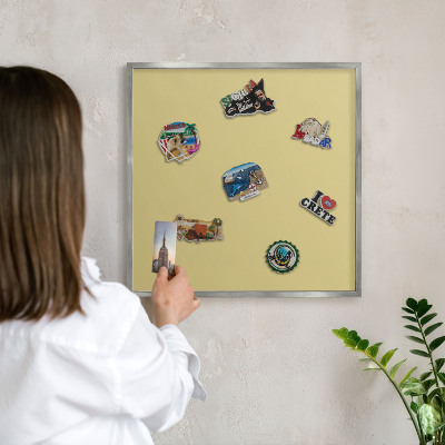 Souvenir magnet display board with a silver frame Vintage yellow