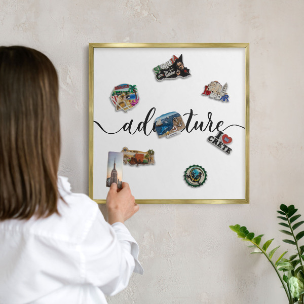Metal magnet board with a gold frame Adventure written