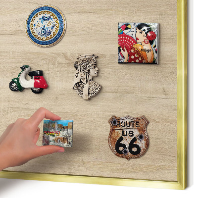 Metal magnet board with a gold frame Wooden background