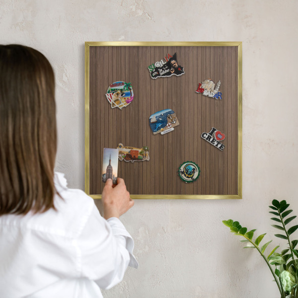 Magnetic board for magnets in a gold frame Wooden background